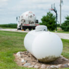 Above ground propane tank with truck in background