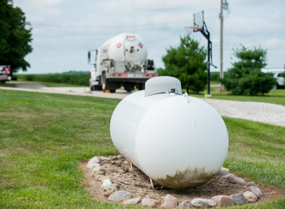 Above ground propane tank with truck in background
