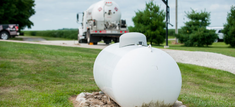Above ground propane tank with truck in background