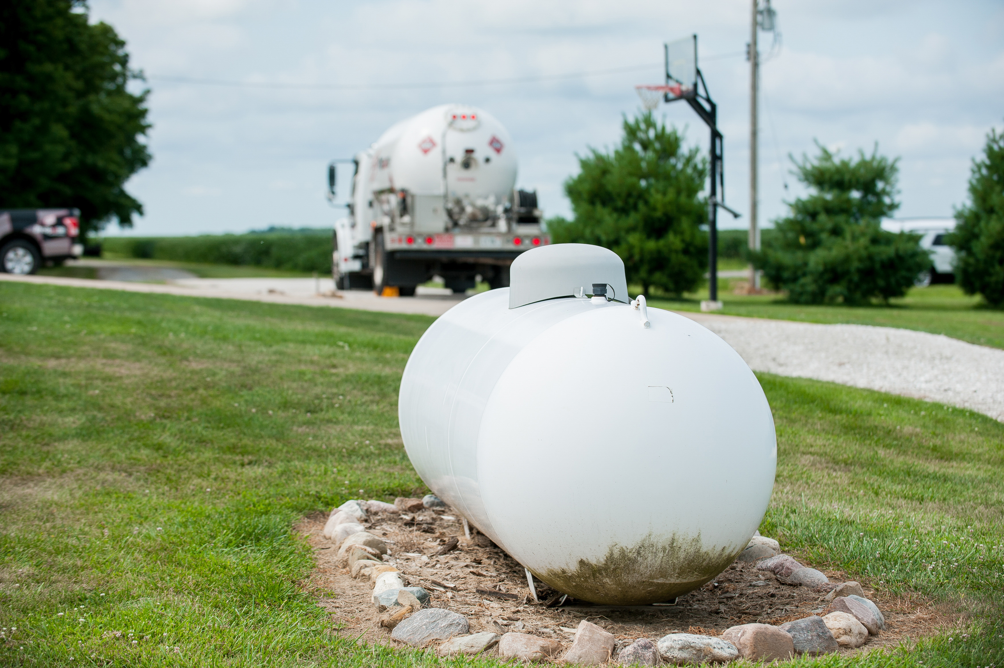 Above ground propane tank with truck in background